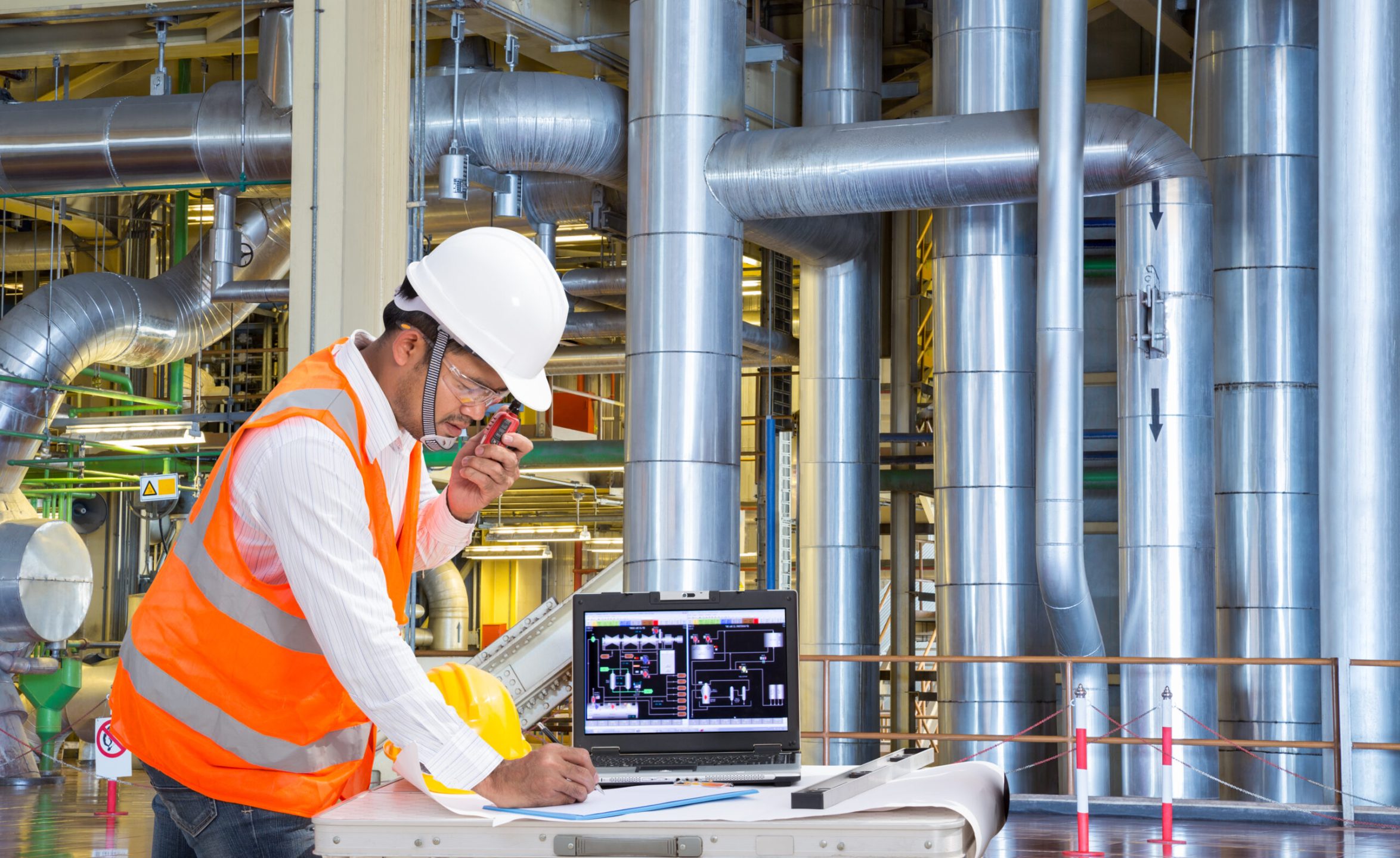 Engineer using laptop computer for maintenance equipment in thermal power plant factory